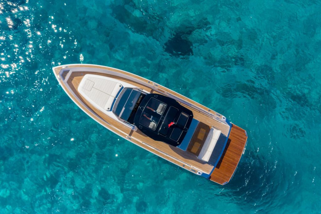 Luxury yacht Wai anchored in a secluded bay with crystal-clear waters in the Cyclades.