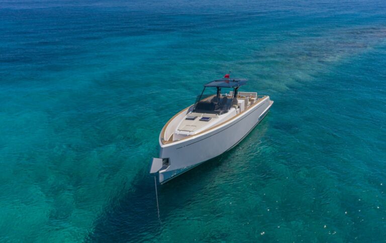 Luxury yacht Wai anchored in a secluded bay with crystal-clear waters in the Cyclades.