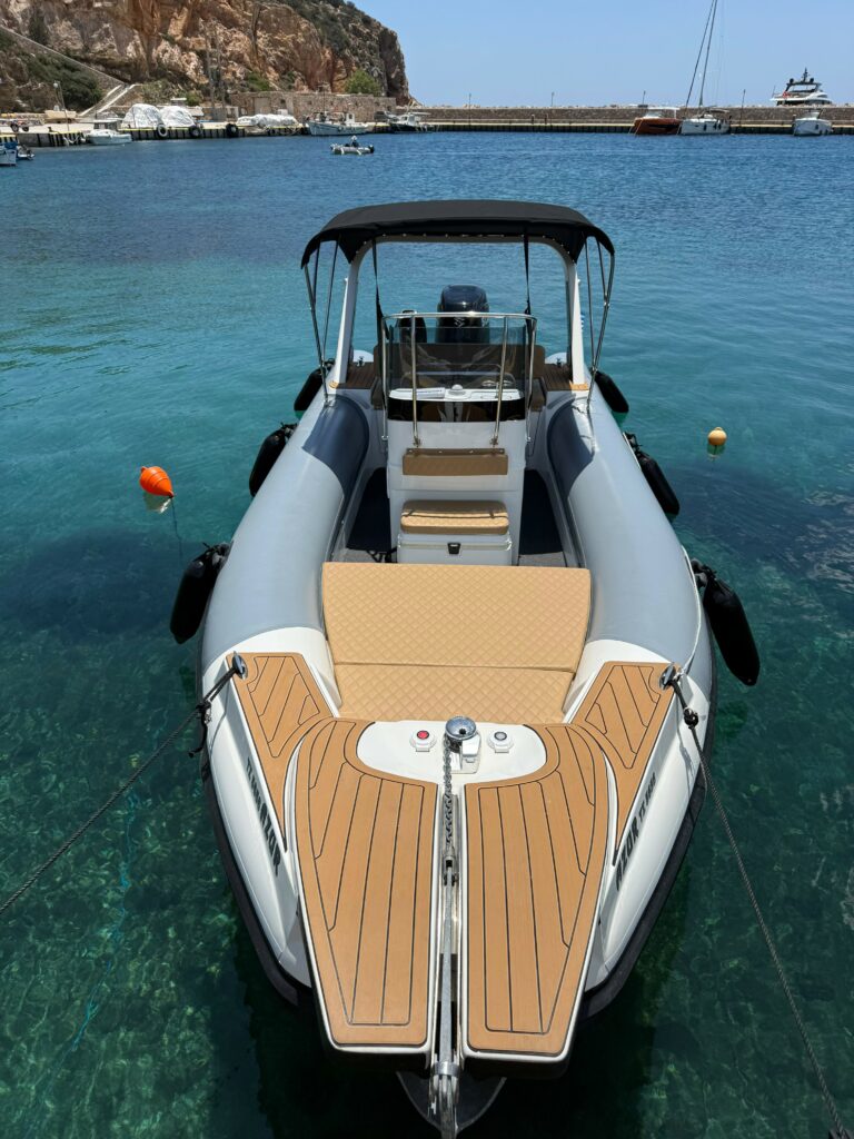A La Mer Azur — boat rental in Sifnos, bow view showing the teak sun deck and shaded centre console