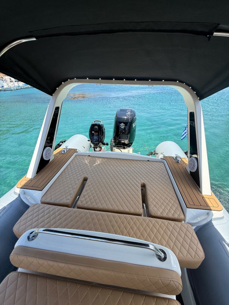 A La Mer Azur — boat rental in Sifnos, stern sun pad and Suzuki engine with Greek flag and swim platform